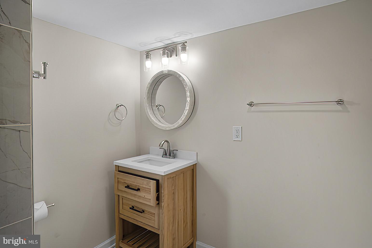 3316 Fairview Road Baltimore, MD 21207 - Photo 13 of 41 a bathroom with a sink and a mirror