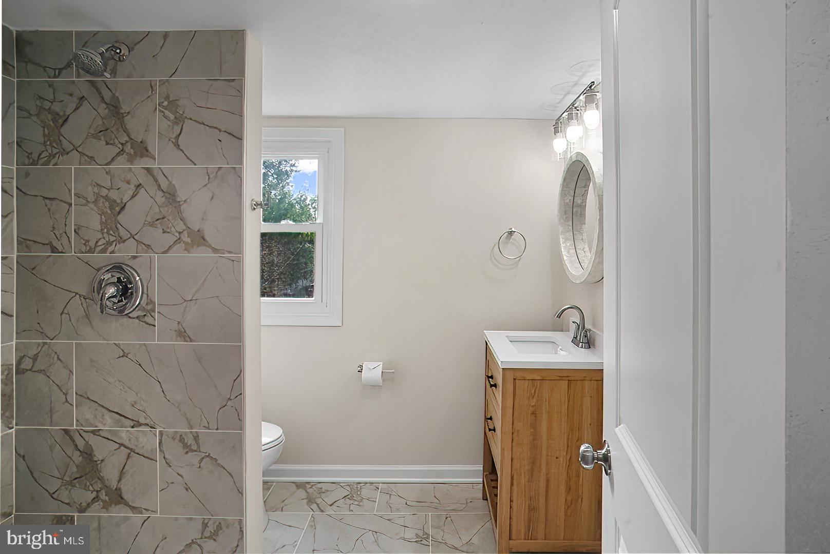 3316 Fairview Road Baltimore, MD 21207 - Photo 14 of 41 a bathroom with a sink and mirror