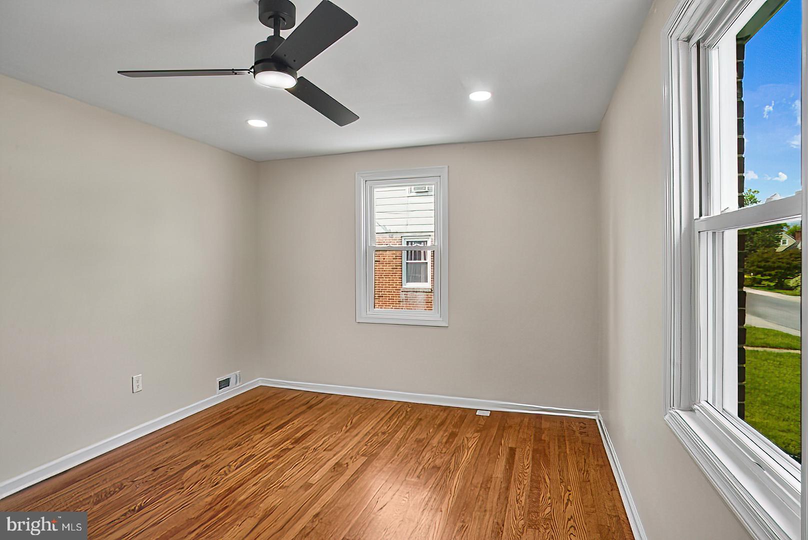 3316 Fairview Road Baltimore, MD 21207 - Photo 16 of 41 wooden floor in an empty room with a window