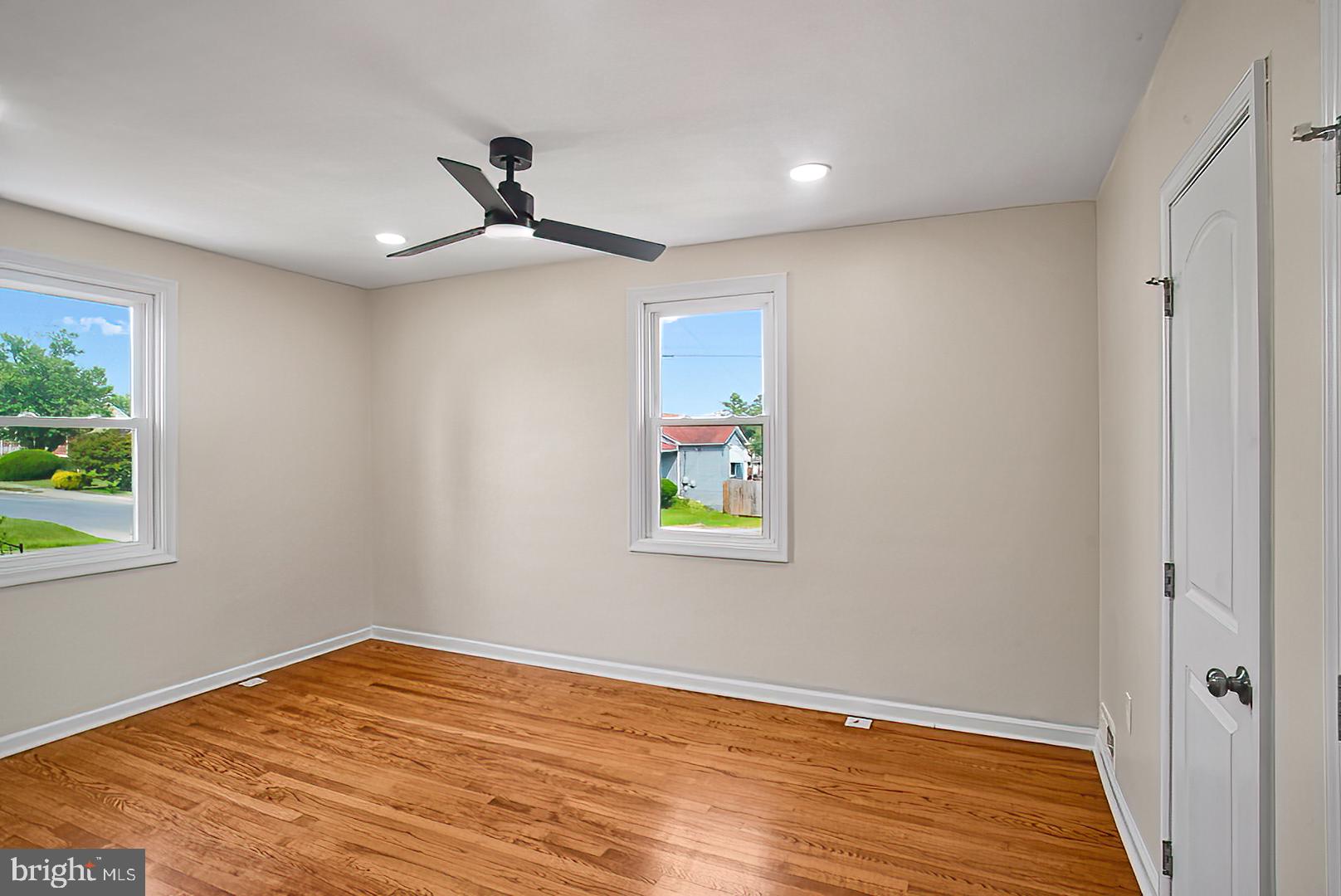 3316 Fairview Road Baltimore, MD 21207 - Photo 17 of 41 a view of empty room with wooden floor and fan