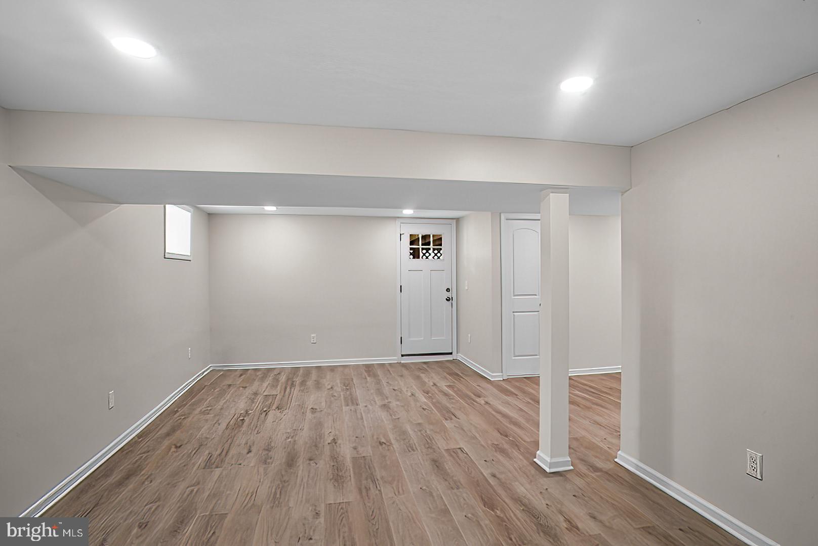 3316 Fairview Road Baltimore, MD 21207 - Photo 25 of 41 an empty room with wooden floor and windows
