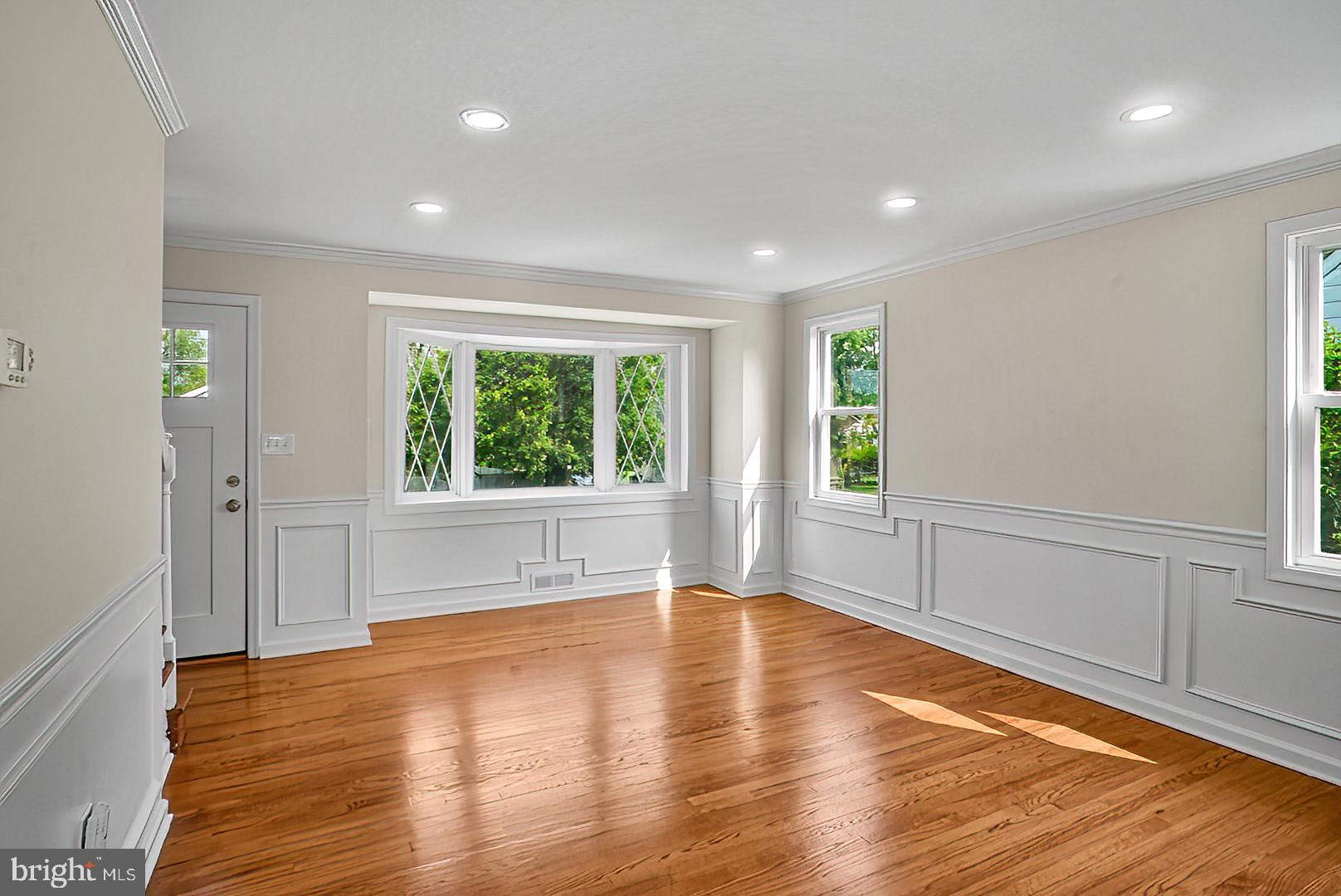 3316 Fairview Road Baltimore, MD 21207 - Photo 4 of 41 a view of an empty room with wooden floor and a window