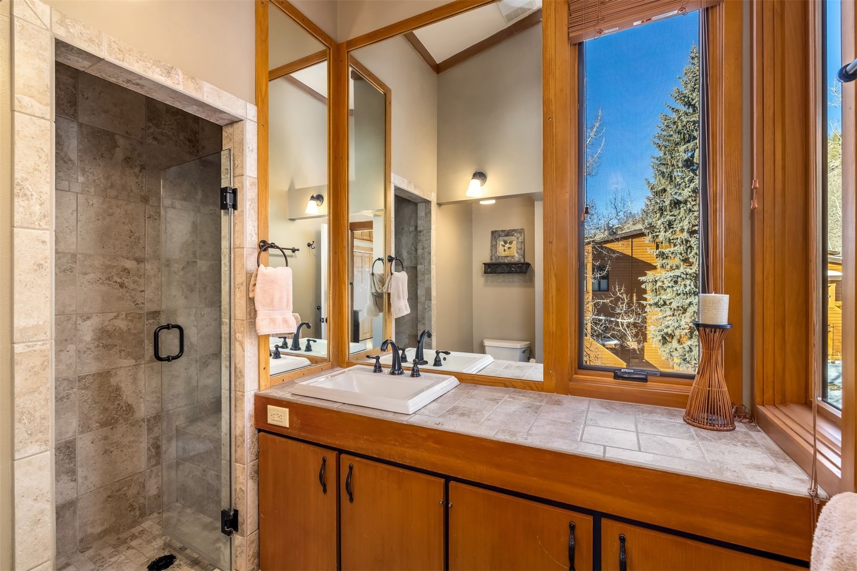 410 Tennis Club Road, Unit 1317 Keystone, CO 80435 - Photo 12 of 42 a bathroom with a granite countertop sink a mirror and a shower