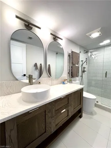 a bathroom with a double vanity sink and a mirror