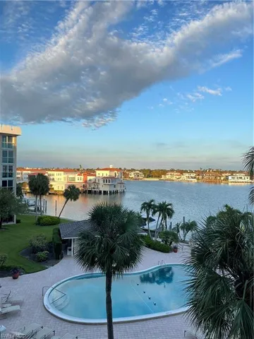 an aerial view of a house with garden space and lake view