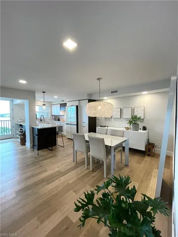 a living room with furniture and a kitchen area