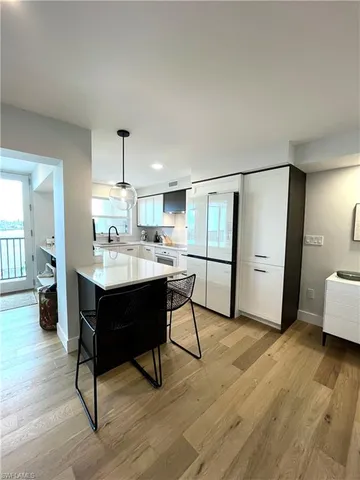 a living room with a couch and a view of kitchen