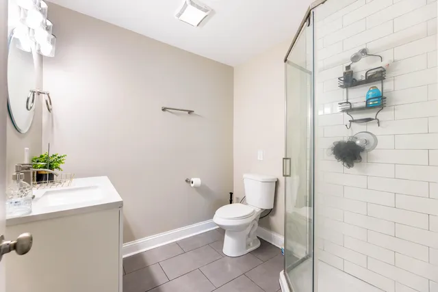 a bathroom with a sink mirror and toilet