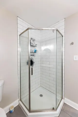 a bathroom with a glass shower door