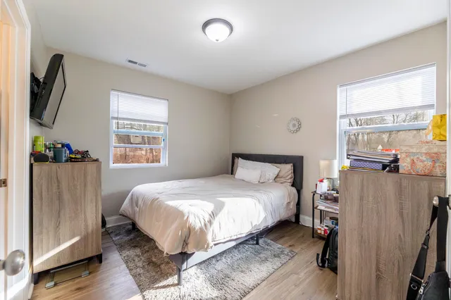 a bedroom with a bed and a window