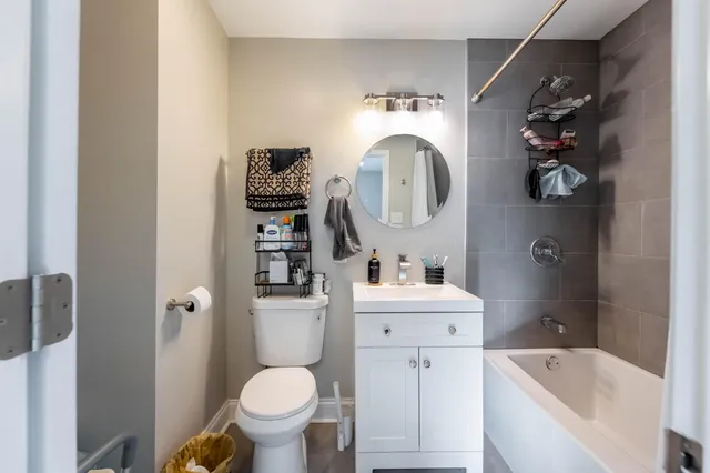a bathroom with a toilet sink and mirror