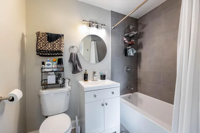 a bathroom with a toilet a sink and a mirror