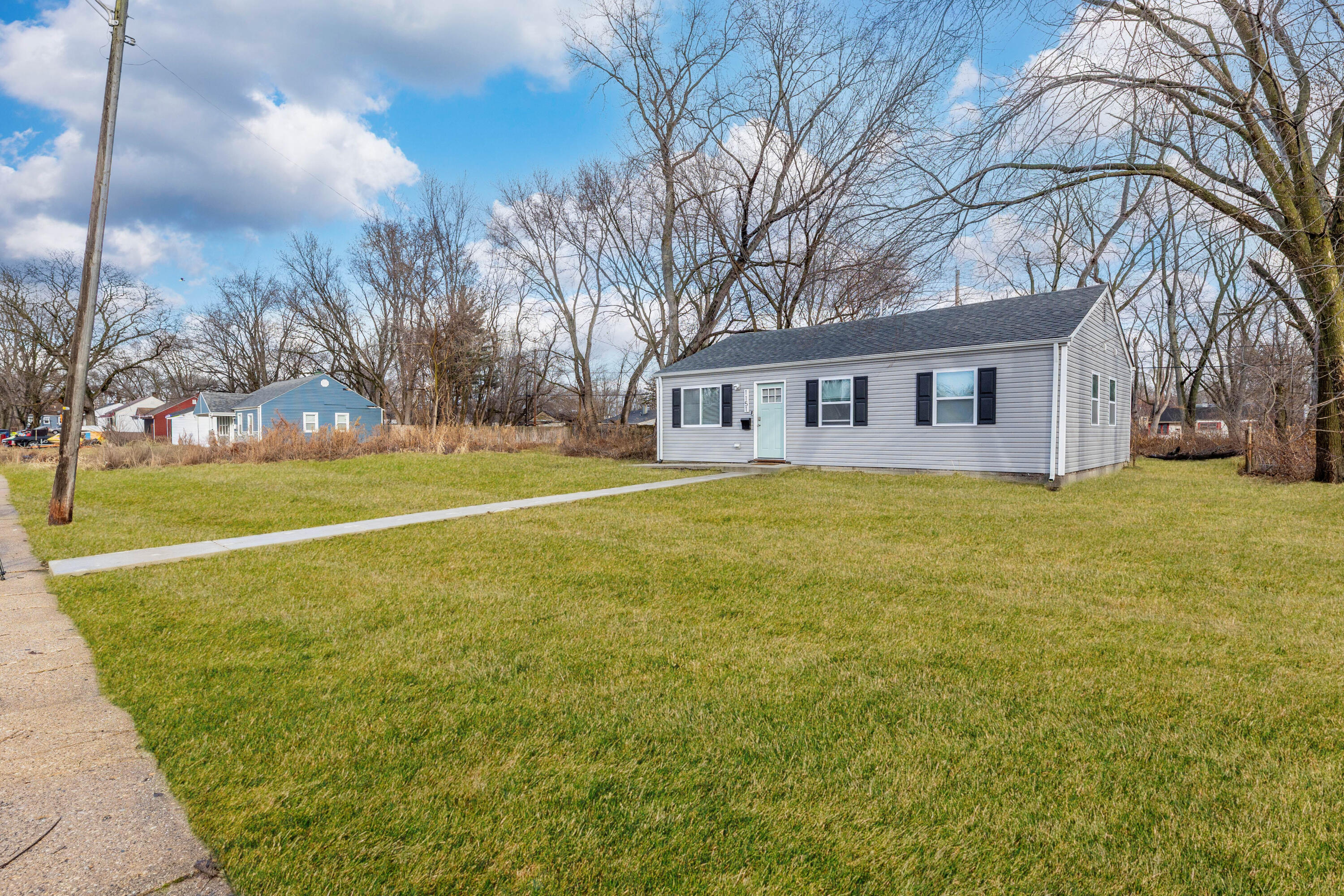 1151 Benton Street Gary, IN 46403 - Photo 20 of 23 a view of a house with a big yard and palm trees