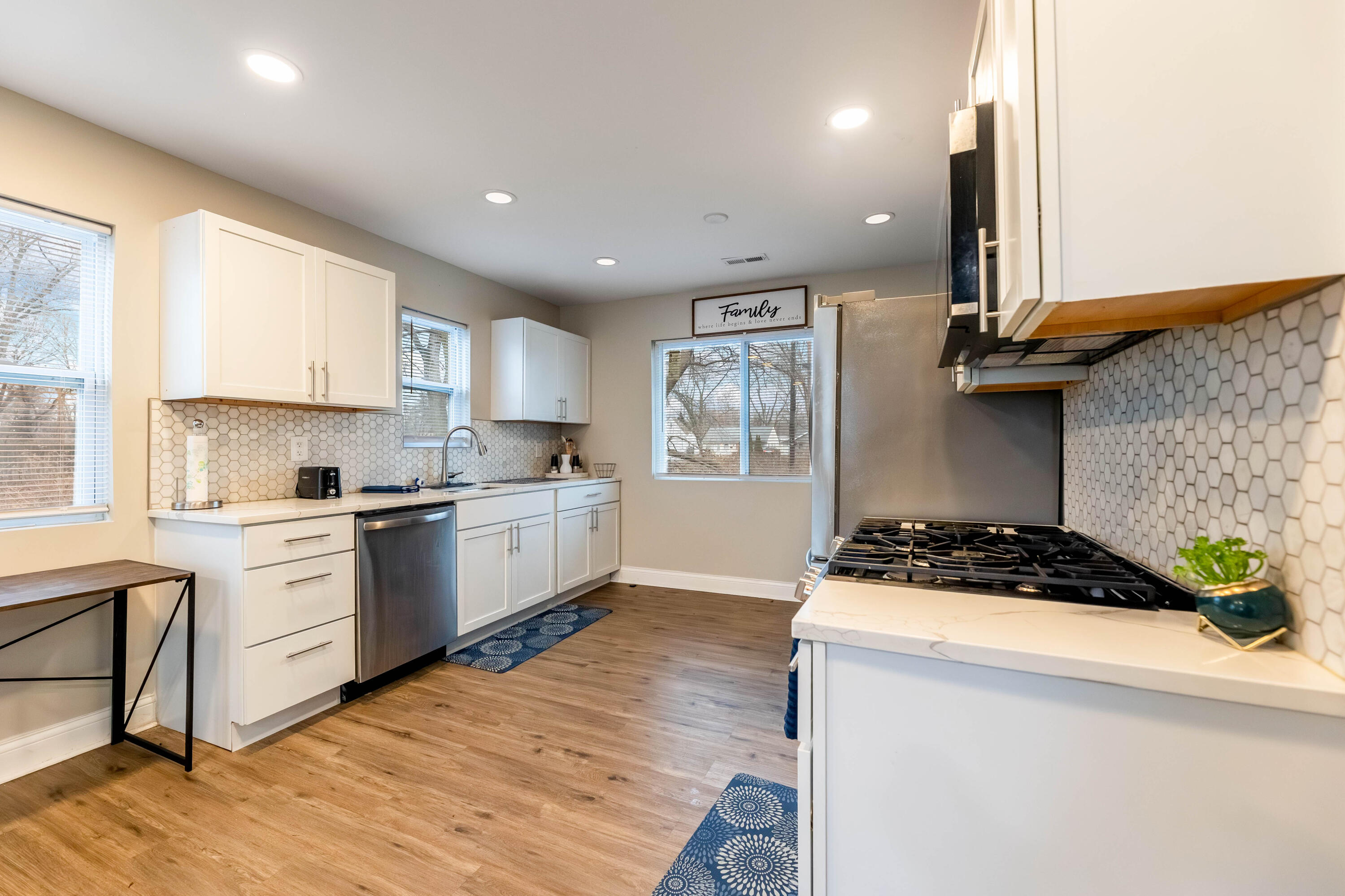1151 Benton Street Gary, IN 46403 - Photo 5 of 23 a kitchen with a stove a sink a refrigerator and window