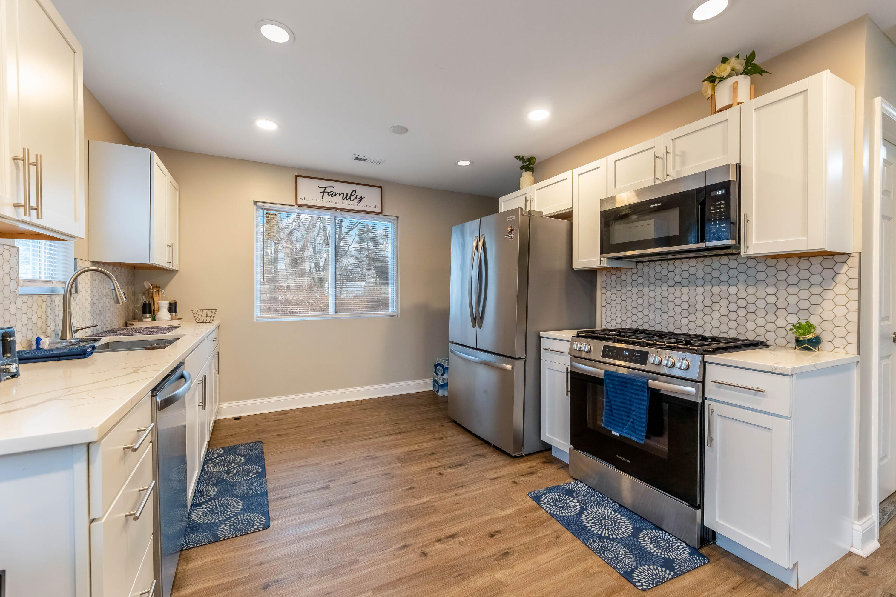 1151 Benton Street Gary, IN 46403 - Photo 8 of 23 a kitchen with stainless steel appliances a stove microwave and sink