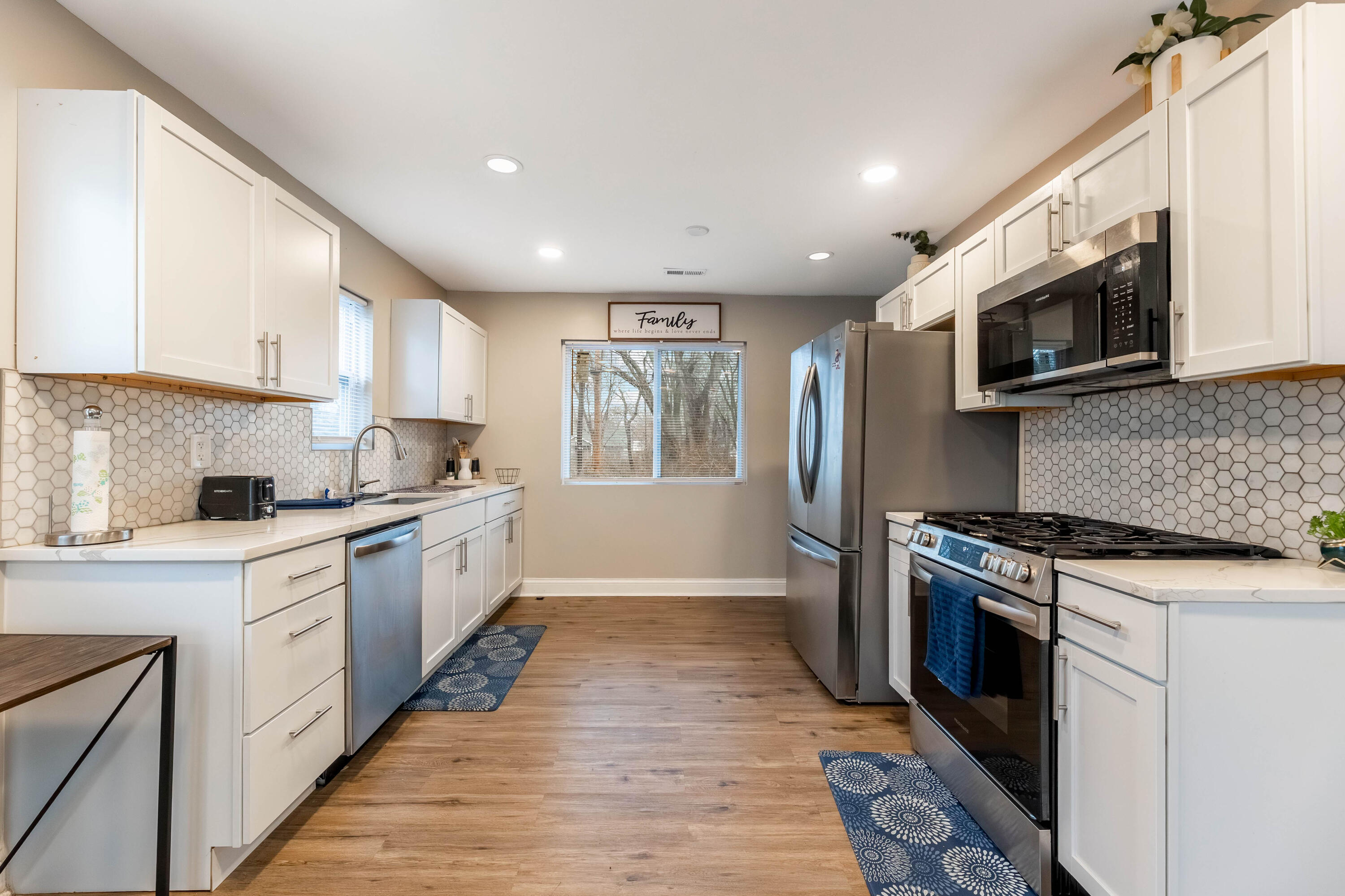 1151 Benton Street Gary, IN 46403 - Photo 9 of 23 a kitchen with stainless steel appliances granite countertop a stove top oven a sink dishwasher and a microwave oven with wooden floor
