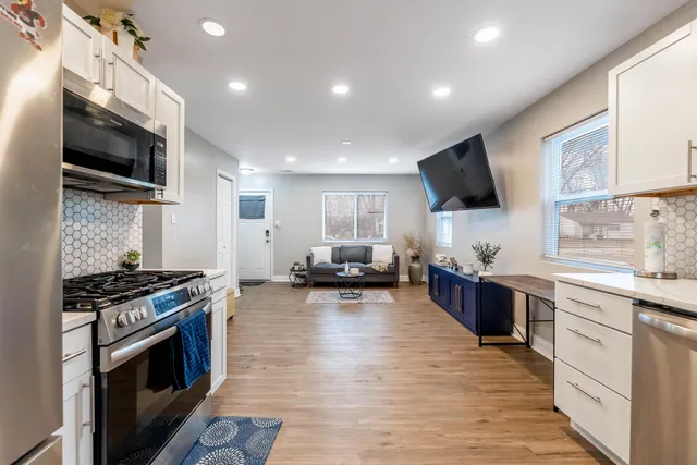 a kitchen with stainless steel appliances a stove sink microwave and cabinets