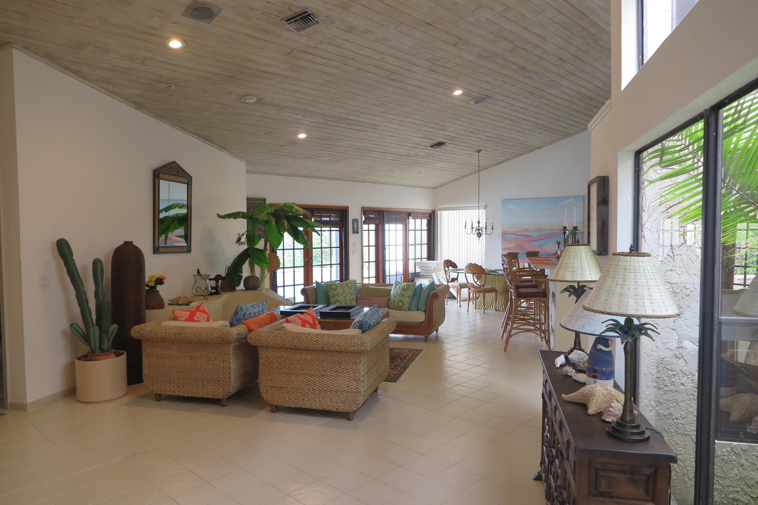 22519 Esplanada Circle Boca Raton, FL 33433 - Photo 3 of 15 a living room with furniture a large window and a flat screen tv