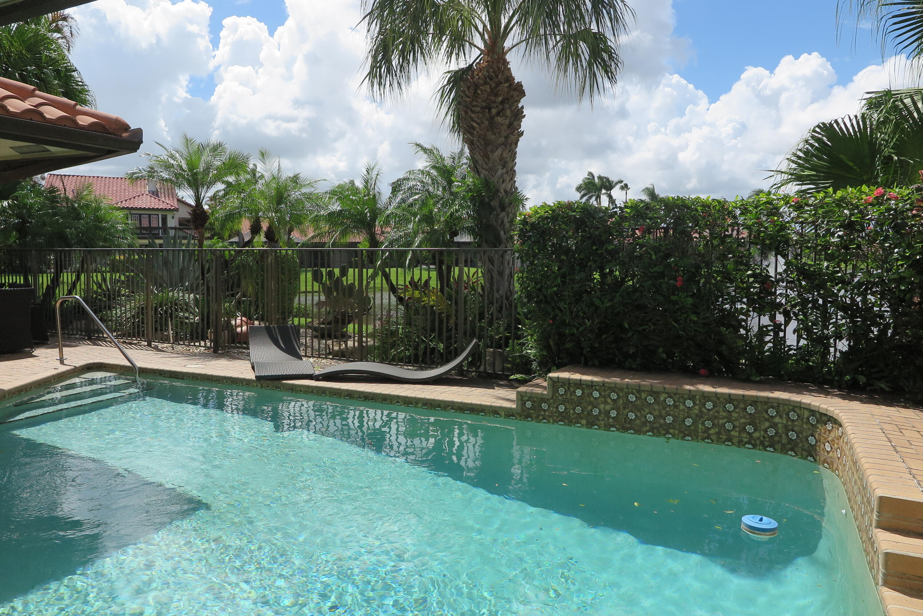 22519 Esplanada Circle Boca Raton, FL 33433 - Photo 10 of 15 a view of a swimming pool with a patio and a garden