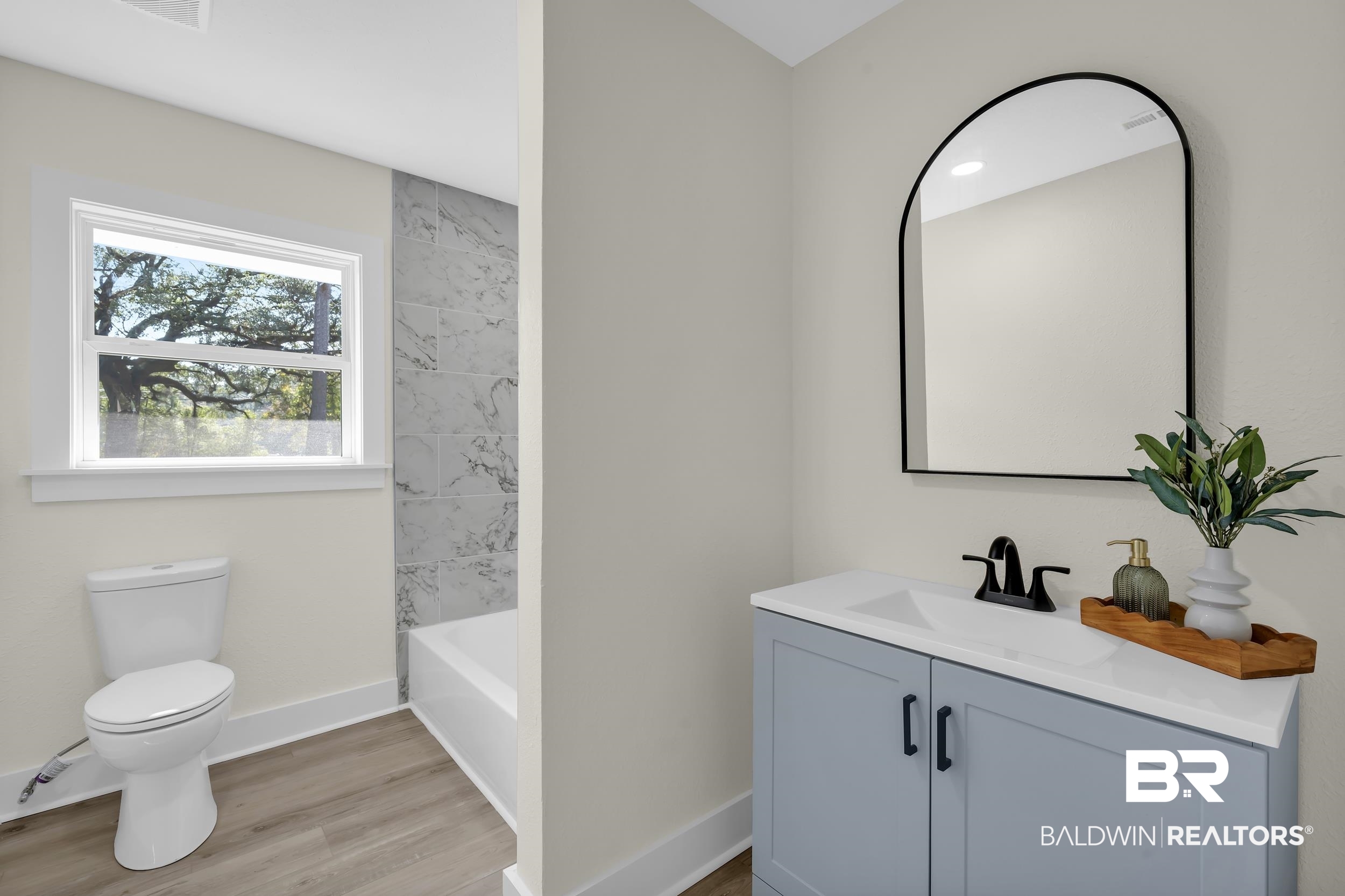 1409 Altair Lane Mobile, AL 36693 - Photo 17 of 23 Bathroom featuring vanity, light wood-type flooring, and shower / washtub combination