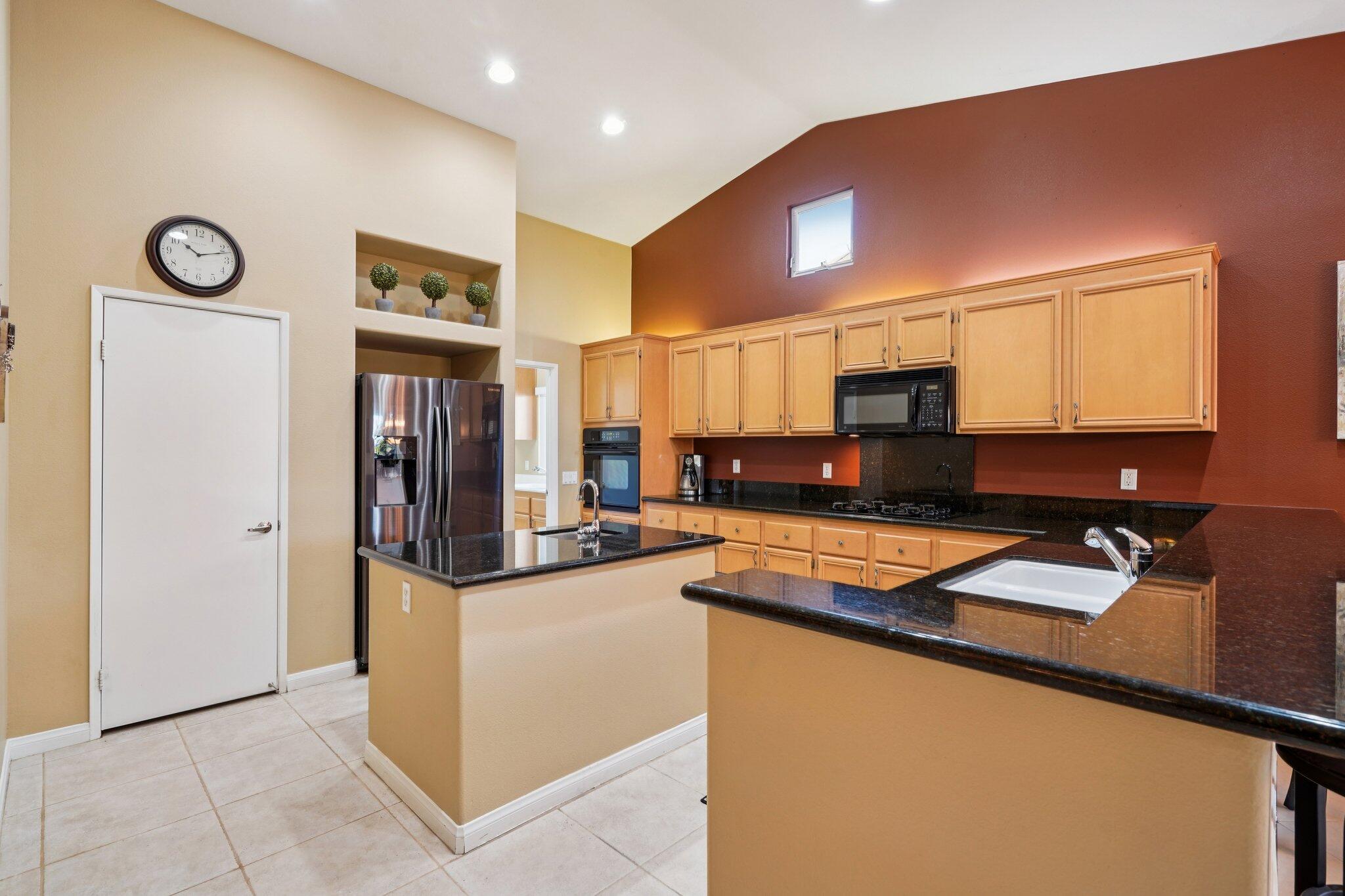 49382 Wayne Street Indio, CA 92201 - Photo 13 of 69 a kitchen with stainless steel appliances granite countertop a refrigerator and a stove top oven