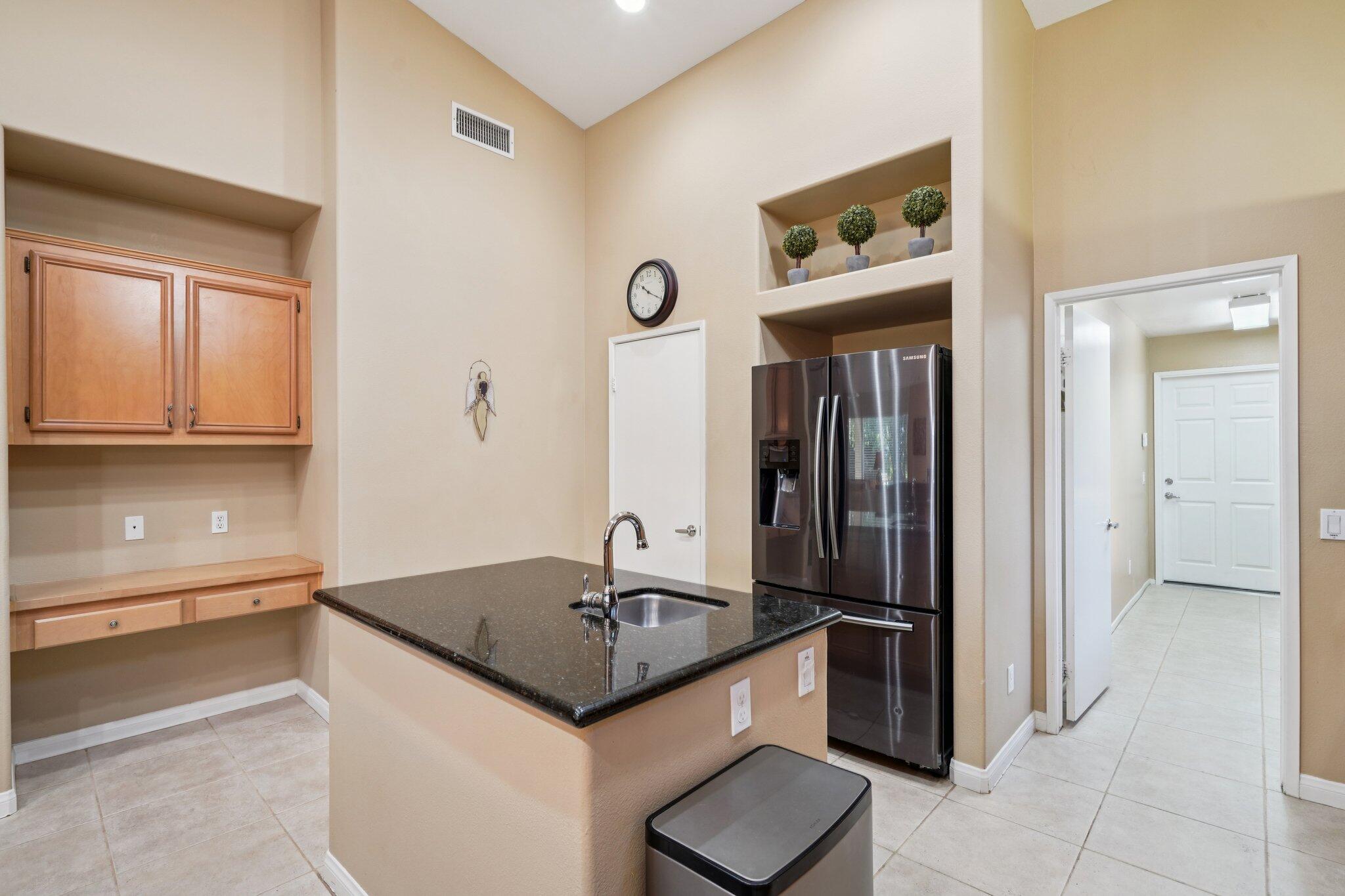 49382 Wayne Street Indio, CA 92201 - Photo 16 of 69 a kitchen with stainless steel appliances granite countertop a sink and a refrigerator
