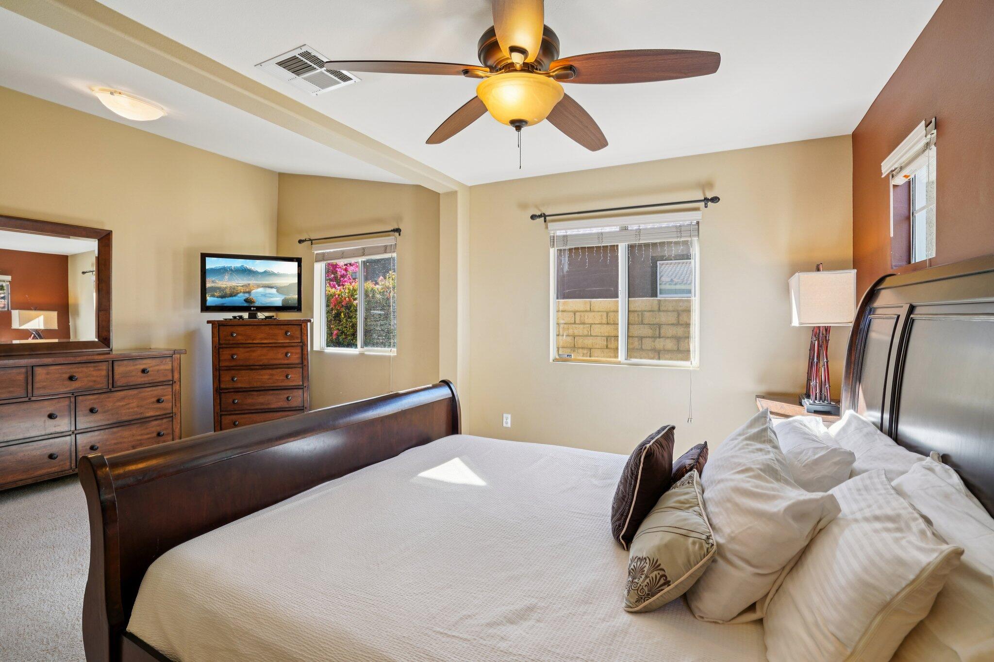 49382 Wayne Street Indio, CA 92201 - Photo 26 of 69 a bedroom with a bed and a chandelier