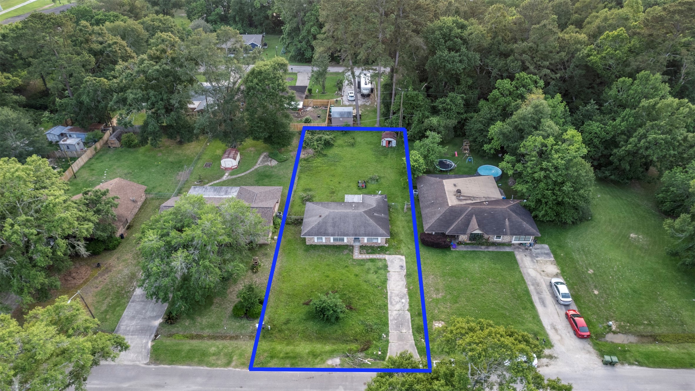 1204 Crescent Boulevard Cleveland, TX 77327 - Photo 23 of 24 an aerial view of a house with swimming pool outdoor seating barbeque oven and green space