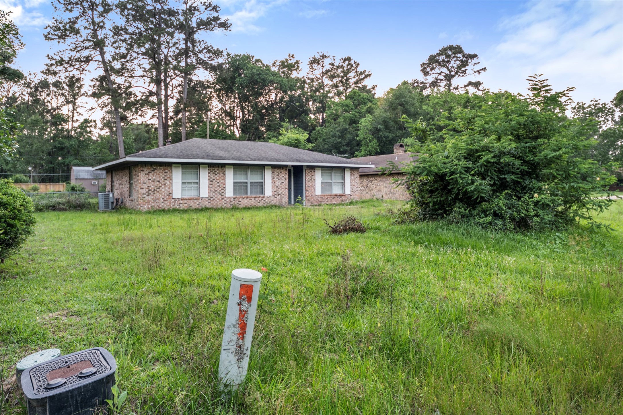 1204 Crescent Boulevard Cleveland, TX 77327 - Photo 4 of 24 a front view of a house with a yard and trees