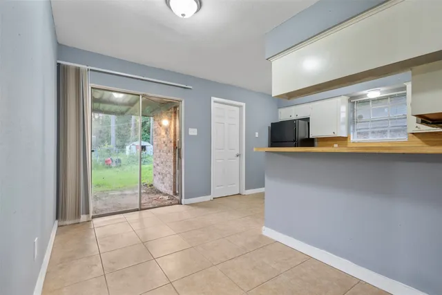 a view of a kitchen with an empty space and a fireplace