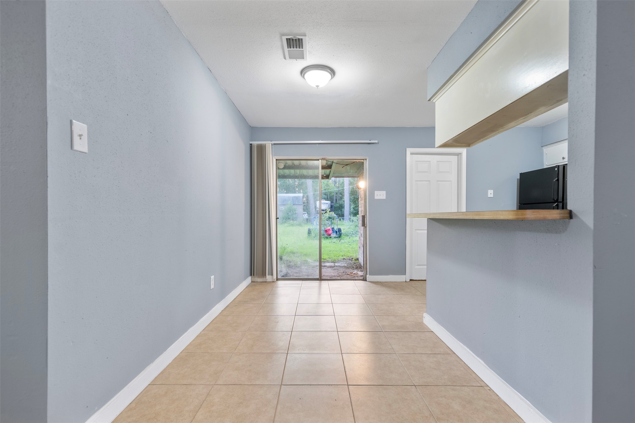 1204 Crescent Boulevard Cleveland, TX 77327 - Photo 9 of 24 a view of a kitchen with an empty space and a window
