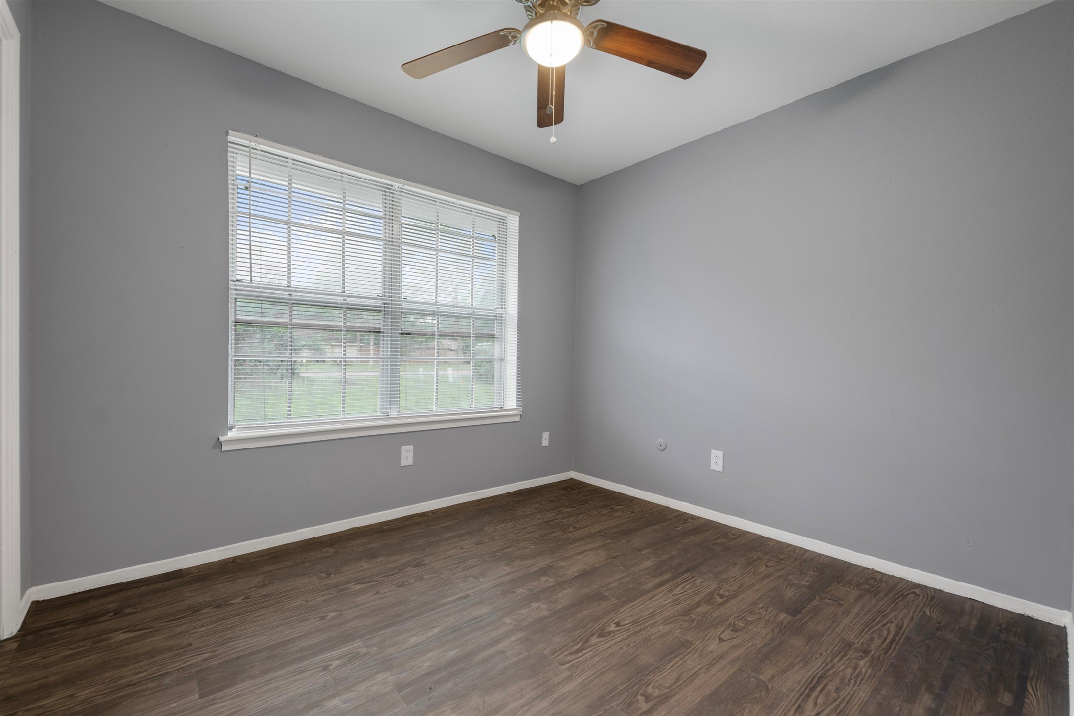 1204 Crescent Boulevard Cleveland, TX 77327 - Photo 10 of 24 an empty room with wooden floor chandelier and windows