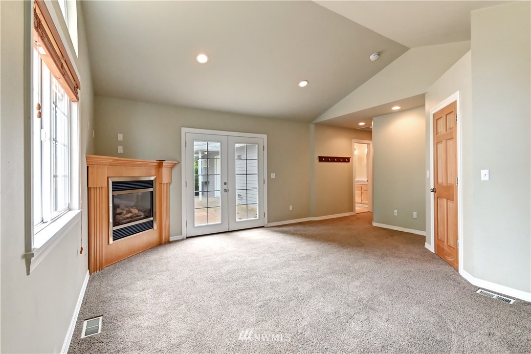 425 South Cabot Road Everett, WA 98203 - Photo 12 of 24 a view of an empty room with a fireplace and a window