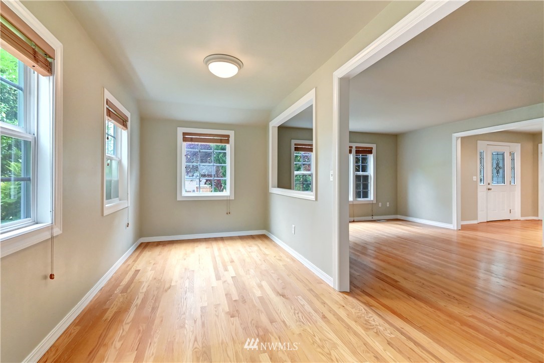 425 South Cabot Road Everett, WA 98203 - Photo 6 of 24 an empty room with wooden floor and windows