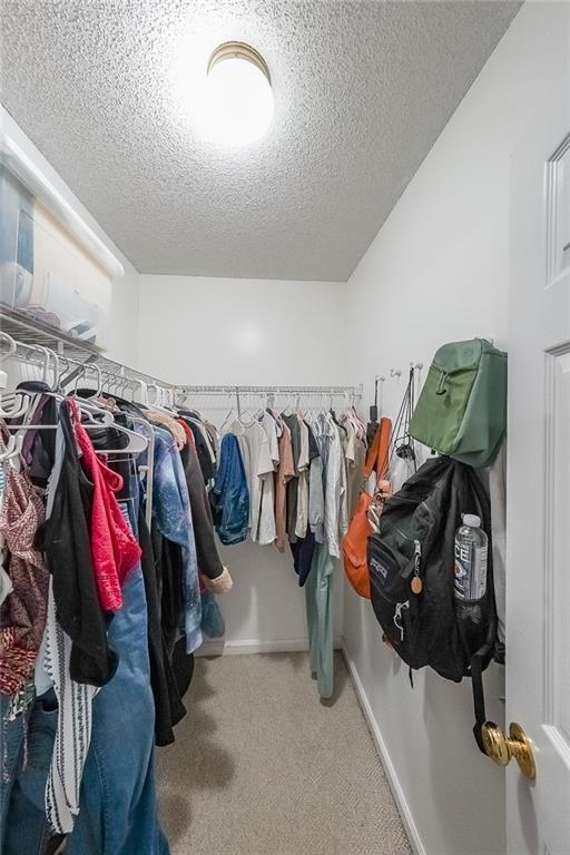 6554 Fox Run Winston, GA 30187 - Photo 23 of 40 a view of walk in closet with clothes and shoes