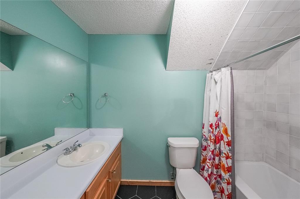 6554 Fox Run Winston, GA 30187 - Photo 25 of 40 a bathroom with a sink a toilet and shower curtain