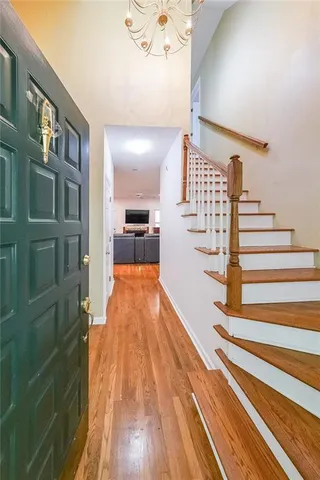 a view of entryway and hall with wooden floor