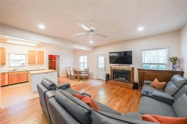 a living room with fireplace furniture and a flat screen tv