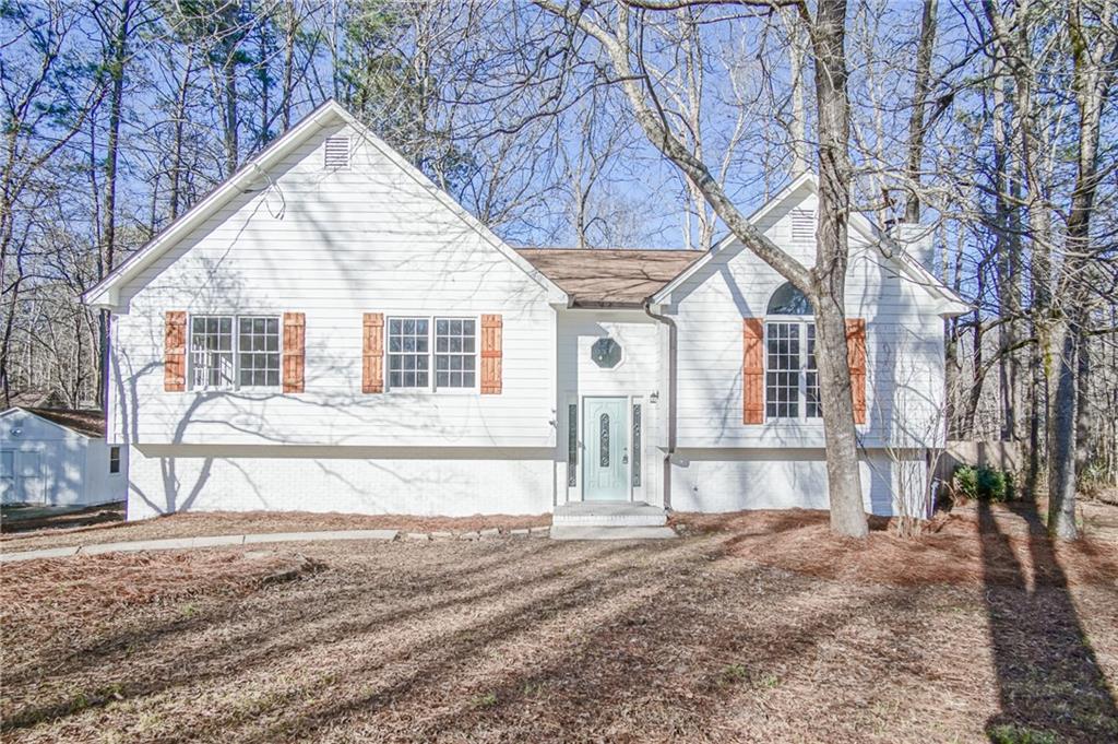 5636 Riding Woods Drive Southwest Powder Springs, GA 30127 - Photo 1 of 1 a view of a house with a yard and large tree