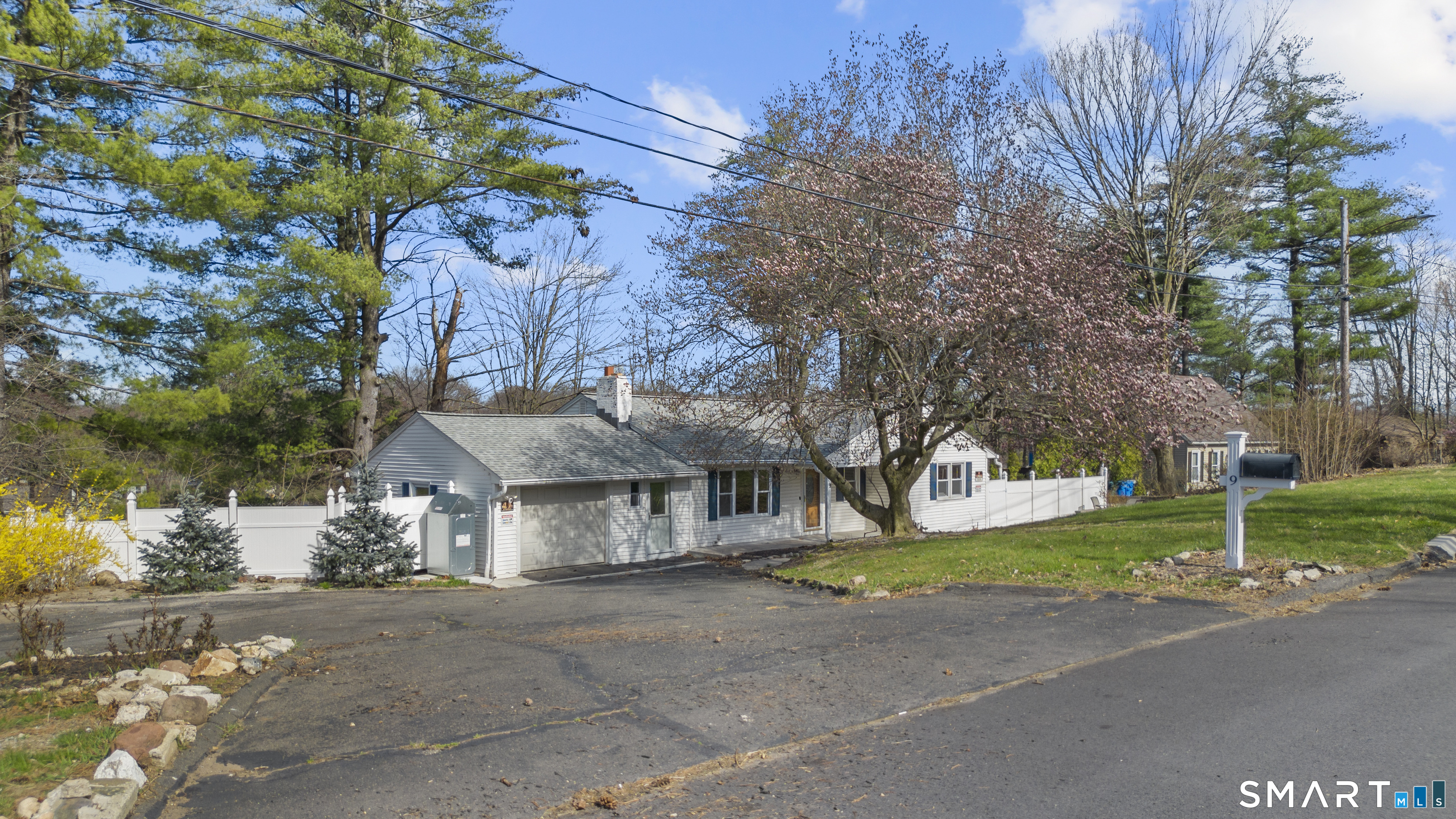 9 Daniel Road, Unit 9B Bristol, CT 06010 - Photo 2 of 16 a view of a house with a yard and large tree