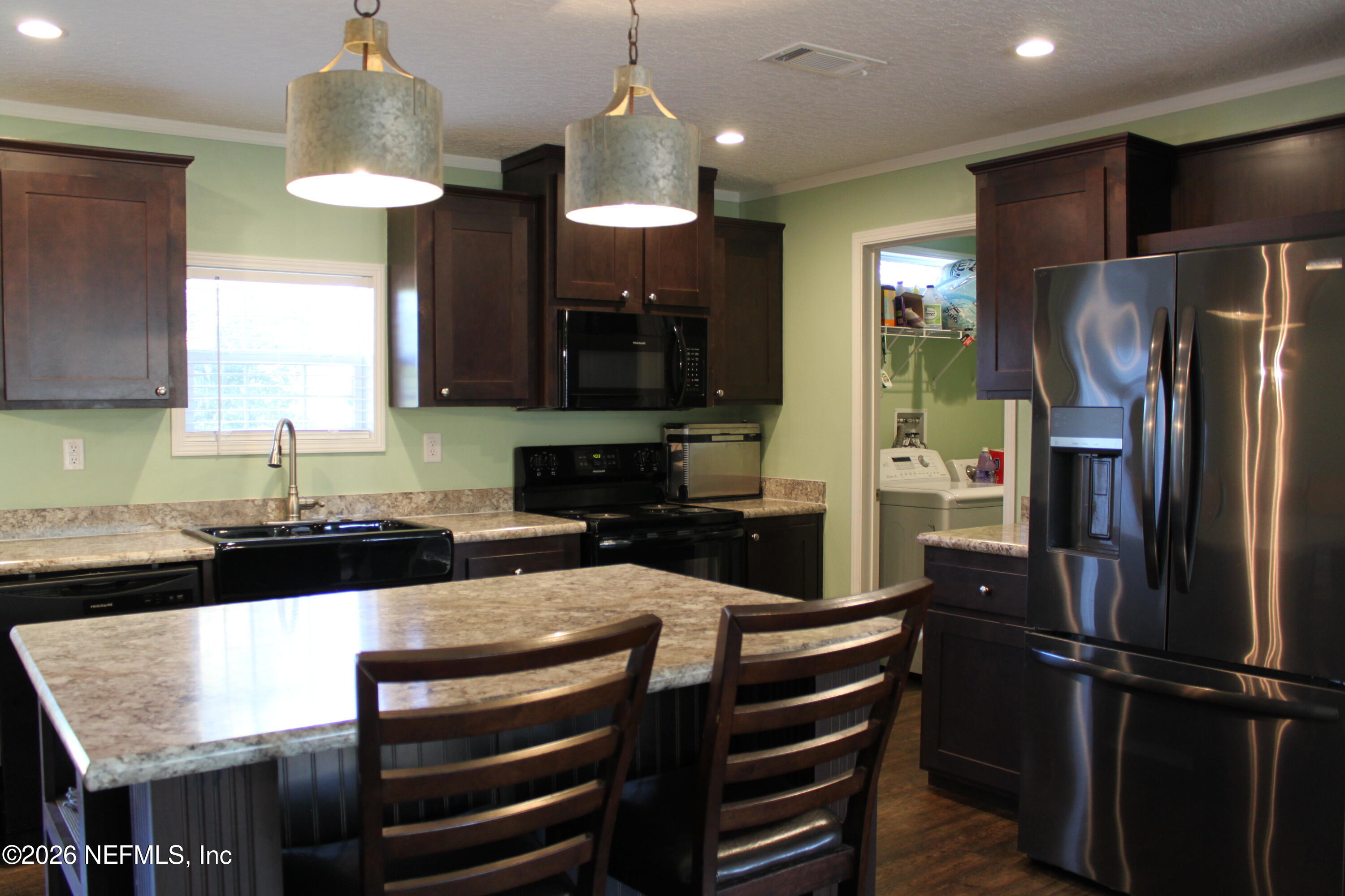 221 Magnolia Road Hawthorne, FL 32640 - Photo 12 of 18 a kitchen with a refrigerator and a sink