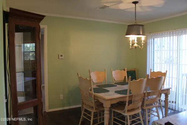 a view of a dining room with furniture and chandelier