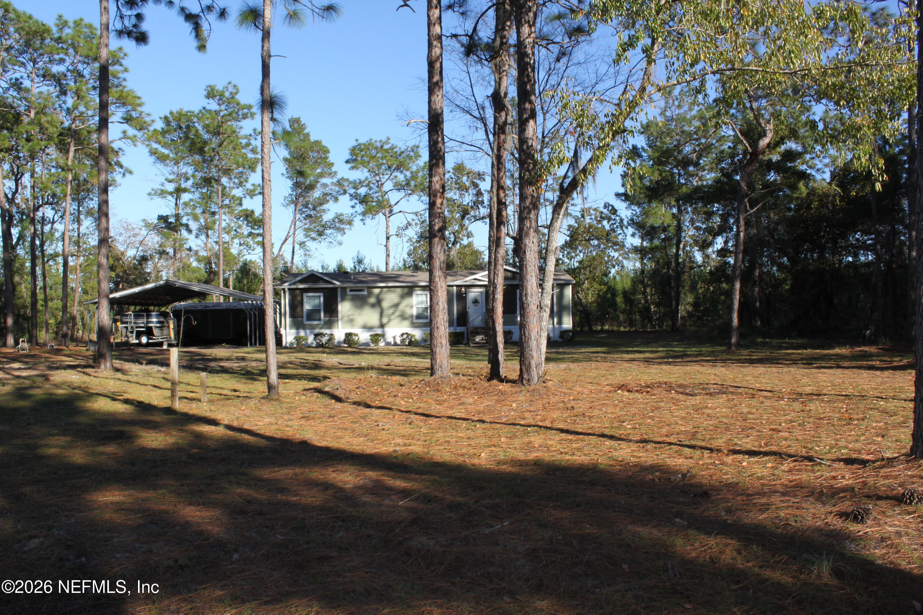 221 Magnolia Road Hawthorne, FL 32640 - Photo 3 of 18 a view of a yard with wooden fence