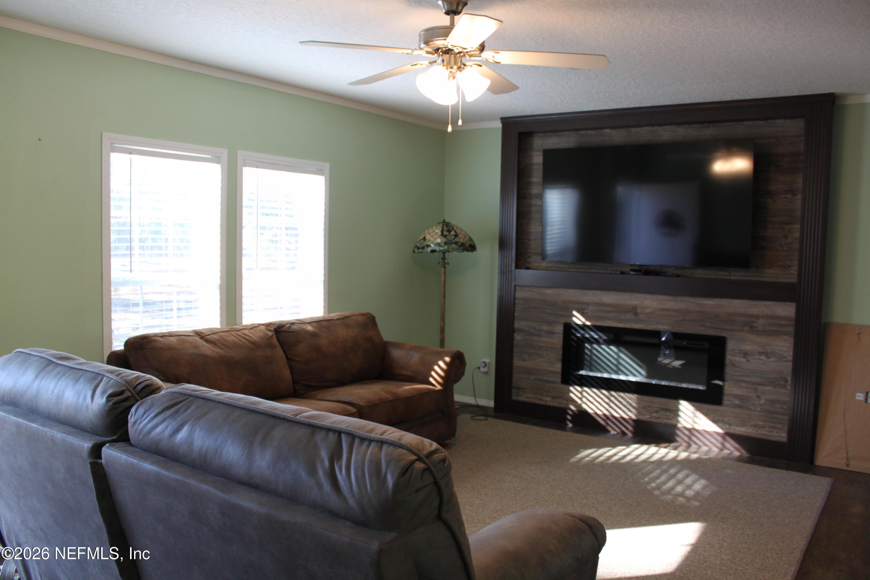 221 Magnolia Road Hawthorne, FL 32640 - Photo 8 of 18 a living room with furniture and a fireplace