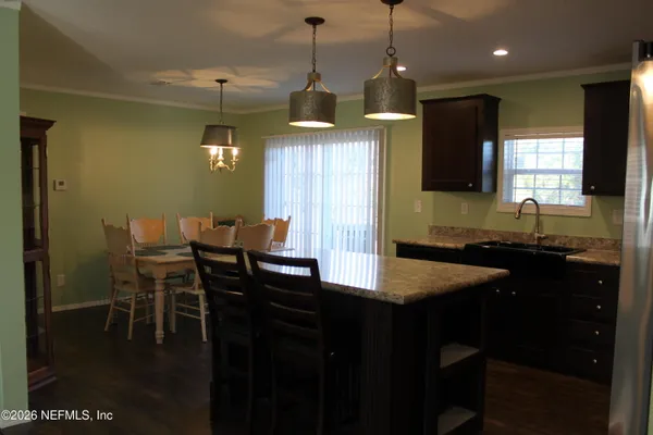 a kitchen with a table and chairs in it