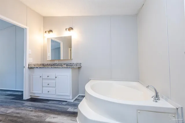 a bathroom with a bathtub and a sink