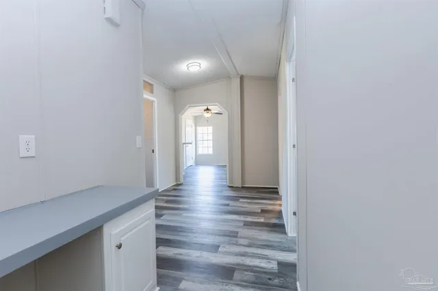 a view of a hallway with wooden floor