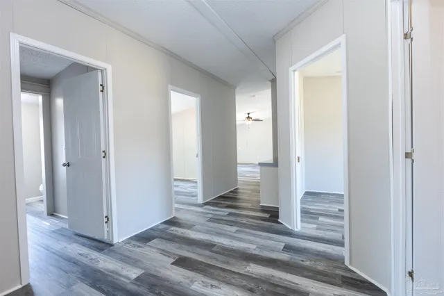 a view of a hallway with wooden floor and front door