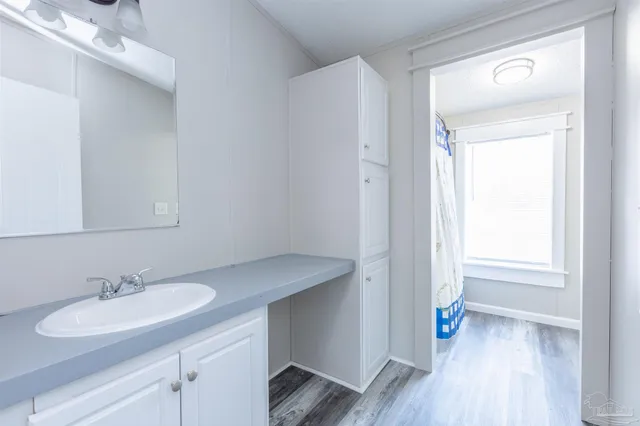 a bathroom with a sink double vanity and a mirror