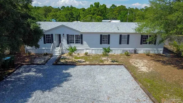 a view of a house with a yard and sitting area